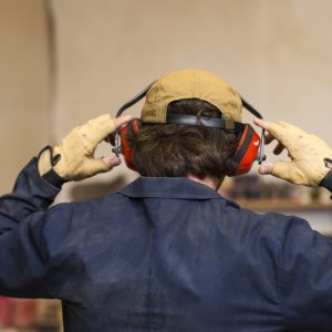 rear-view-handyman-wearing-ear-defender-his-ear